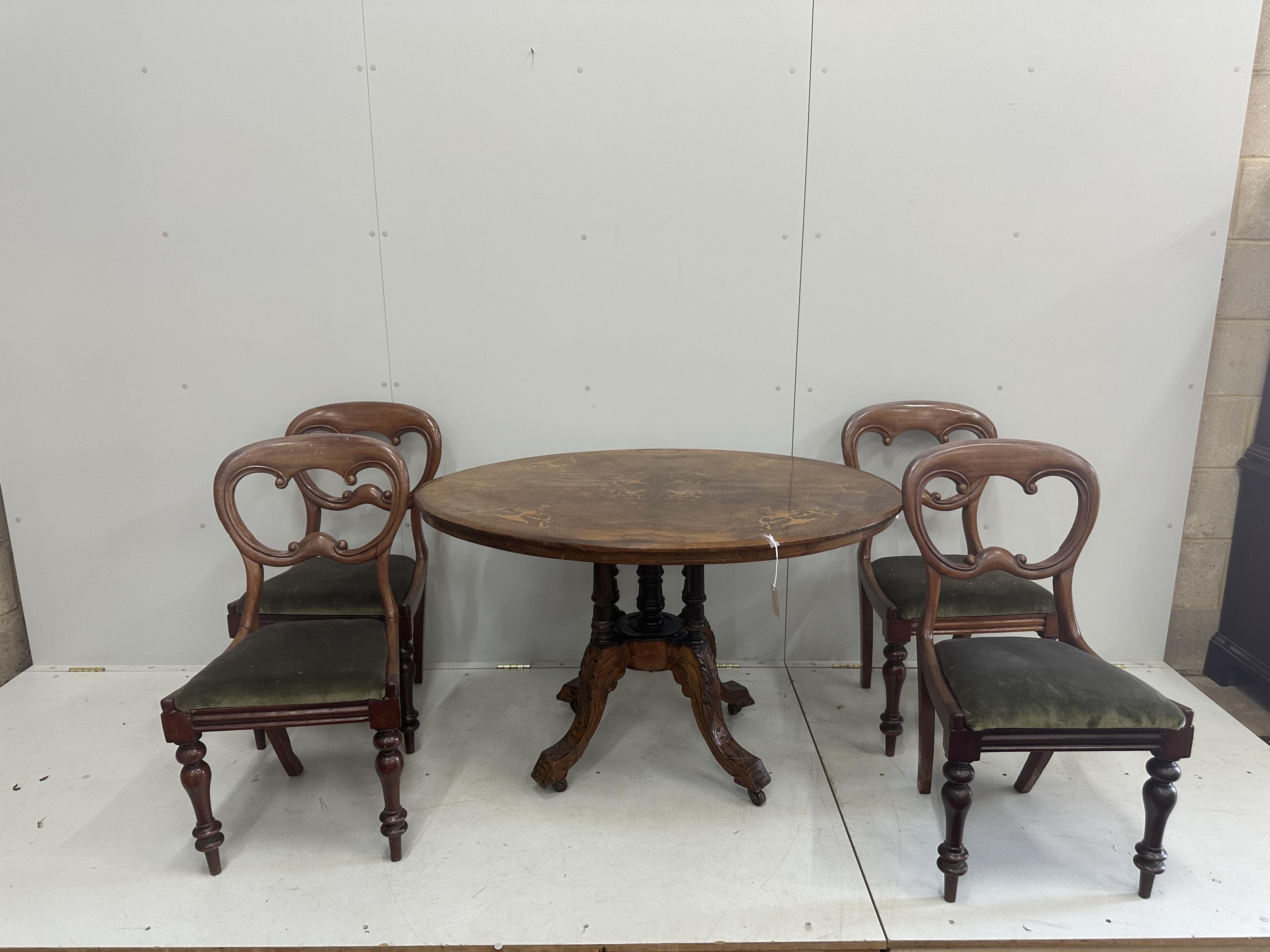 A Victorian inlaid walnut oval loo table, width 120cm, depth 86cm, height 72cm, lacks bolts together with four Victorian mahogany balloon back dining chairs. Condition - poor to fair